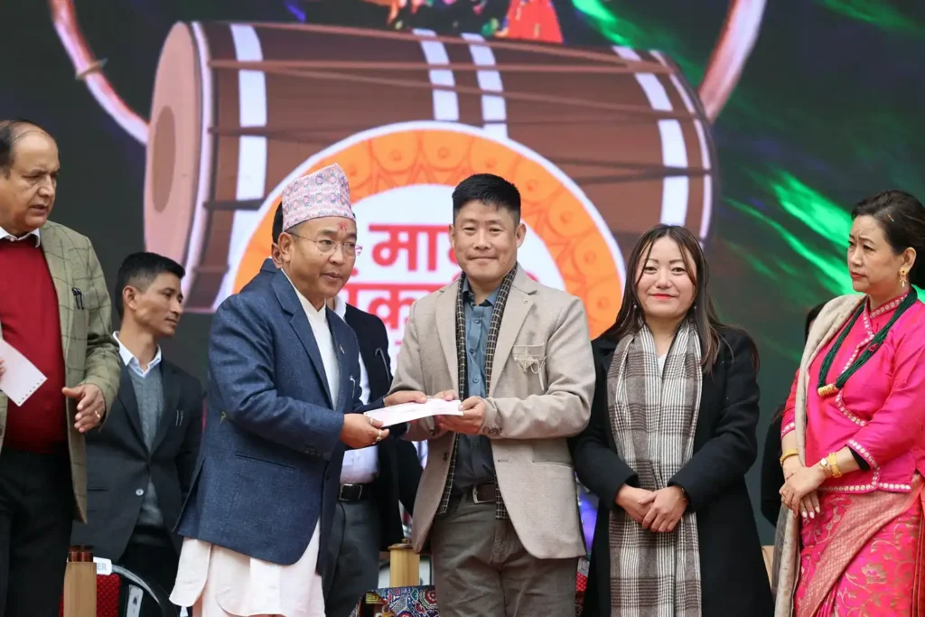 Indra Kari Subba being honoured by Sikkim Chief Minister Prem Singh Tamang Golay on a public stage, with his wife Sasita Subba standing beside him and the Chief Minister’s wife present, marking a formal recognition ceremony celebrating contributions to Sikkim’s culture and community.