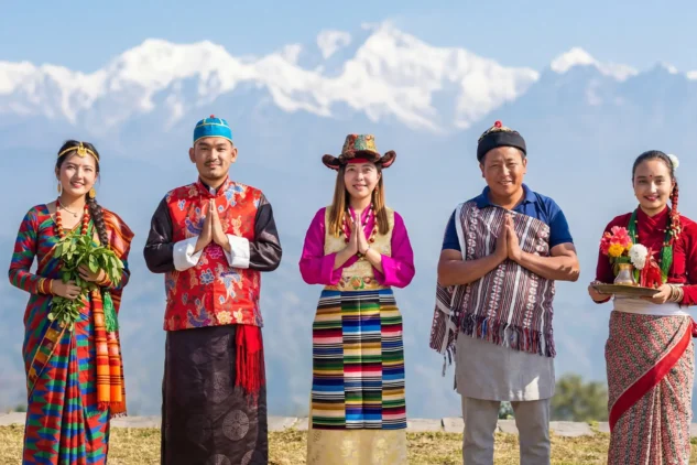 People from the Lepcha, Nepali, Limboo Tsong, and Bhutia communities of Sikkim standing together in traditional attire, greeting with folded hands against a backdrop of the Himalayan mountains, representing the cultural diversity and harmony of Sikkim.