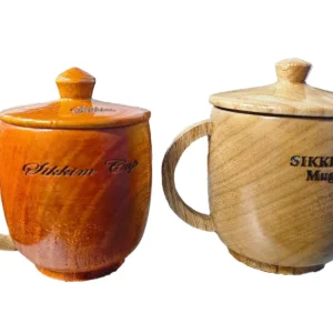 Handcrafted wooden tea cups with lids and handles featuring custom Sikkim engravings from Khechuperi Bamboo House